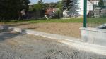 Upravený terén za obrubníky na parkovišti u hřbitova